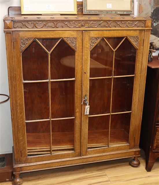 A carved oak glazed display cabinet W.106cm
